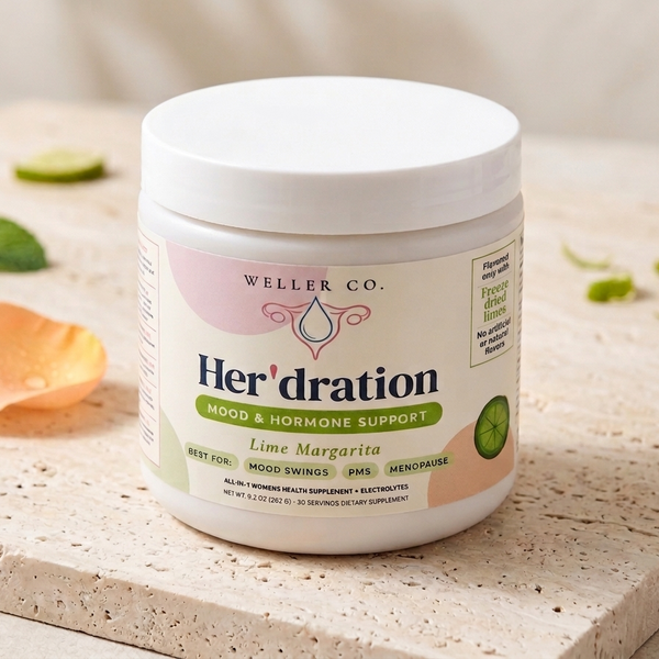 Tub of 'Her'dration' supplement on a stone surface with lime slices.